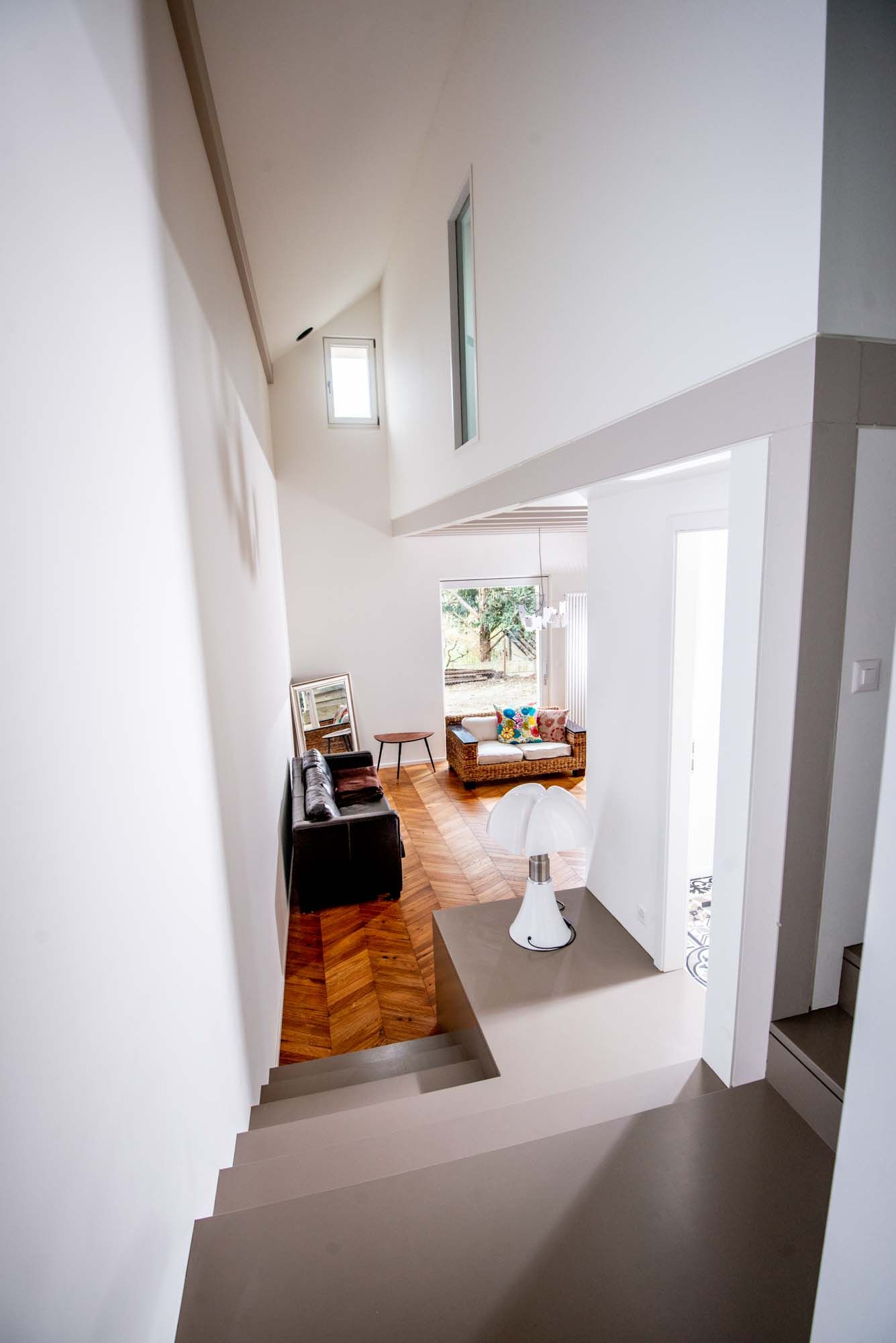 A staircase leading up to a living room in a house.