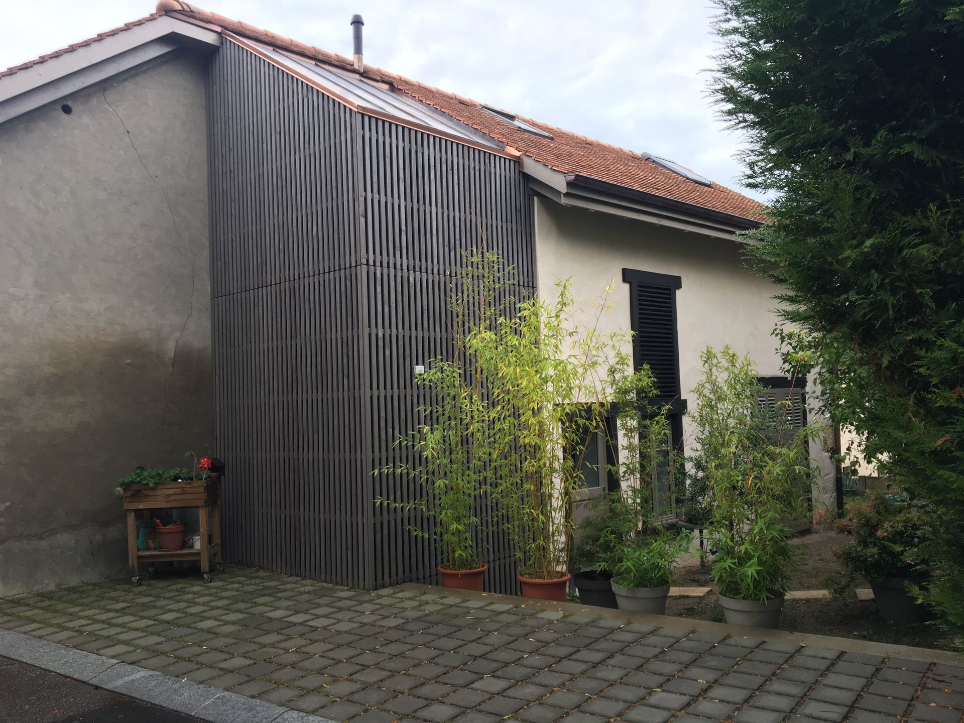 A house with a brick driveway in front of it