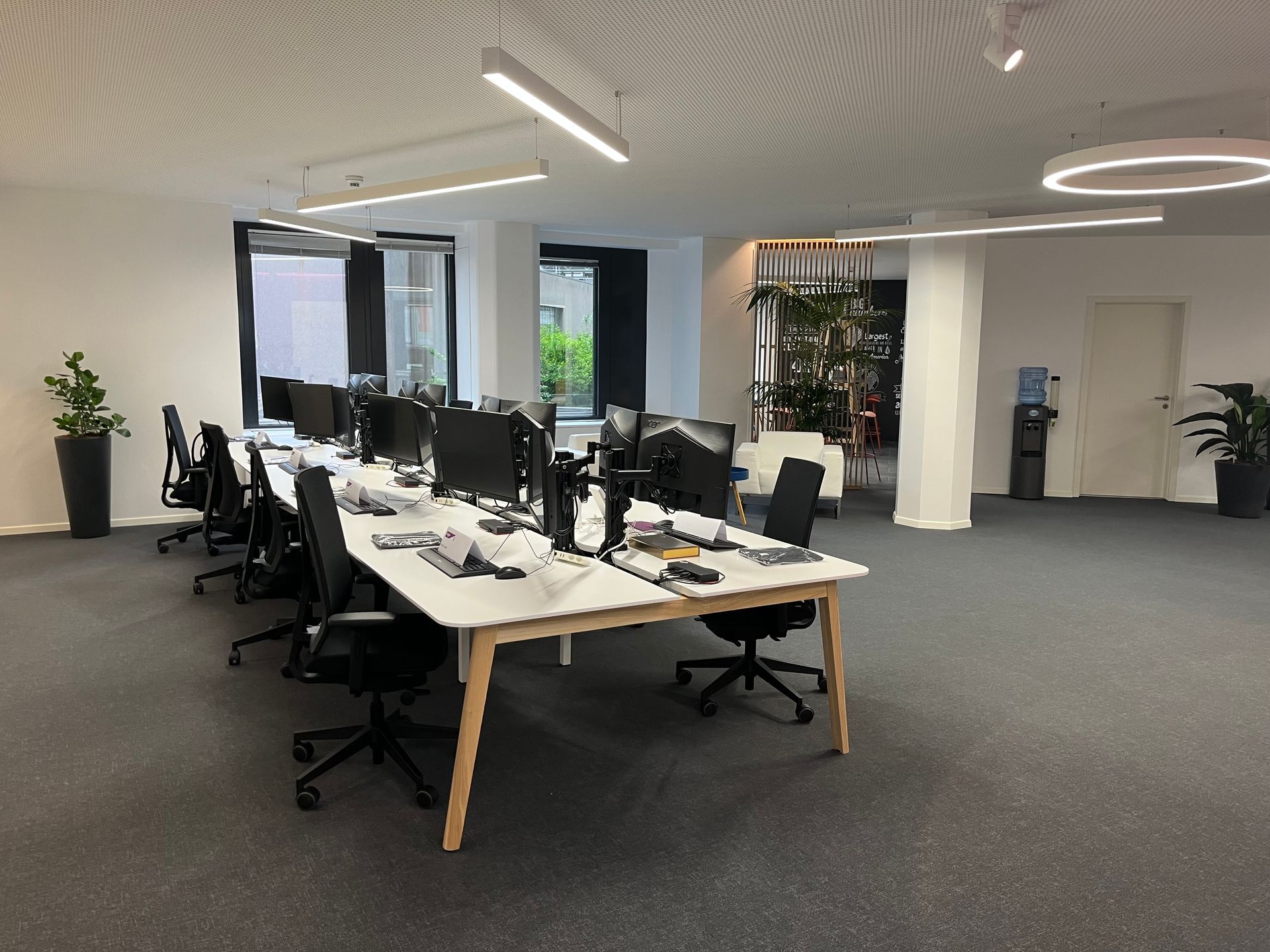 A large office with a lot of desks and chairs.