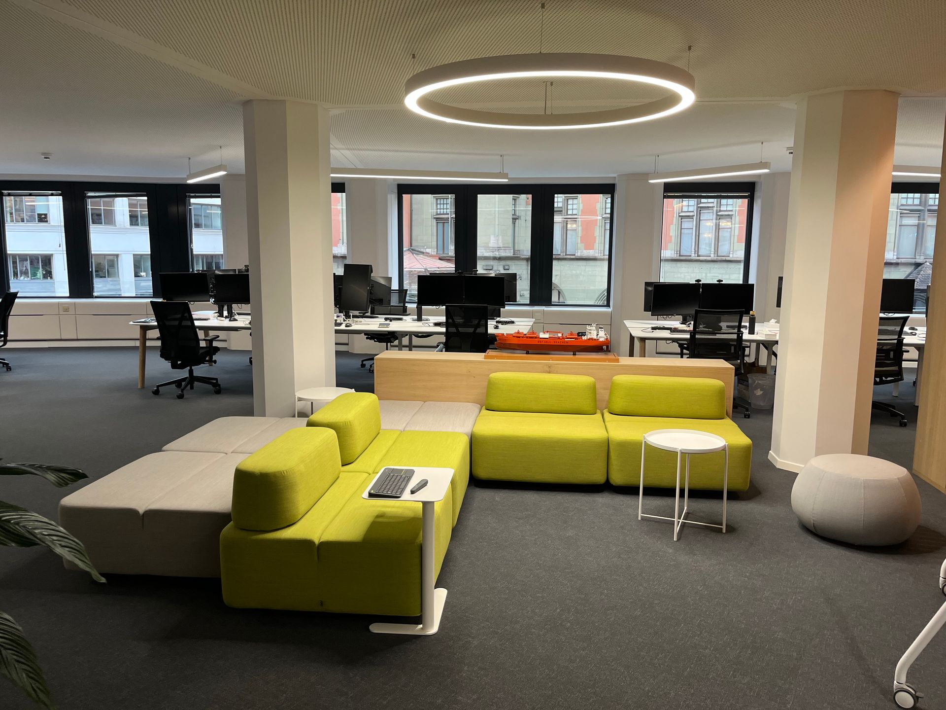 A living room with a green couch and a table