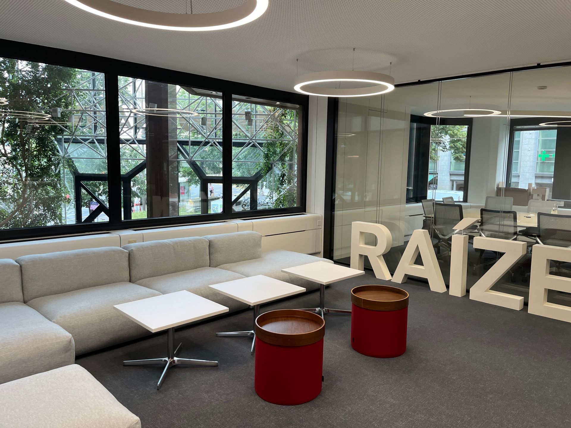 A living room with a couch , tables and a sign that says raize