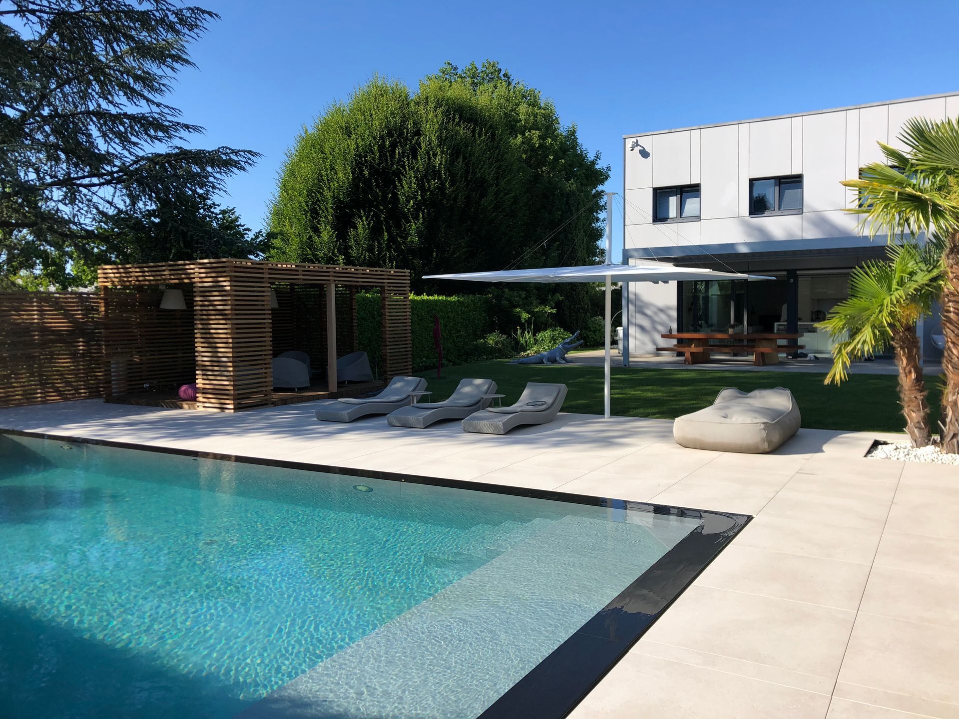 A large swimming pool in front of a house