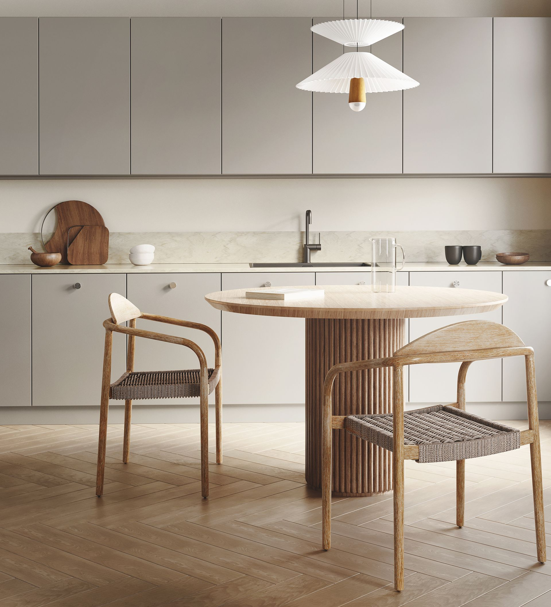 Cuisine avec placards gris clair, table ronde, chaises en bois et suspension lumineuse originale.