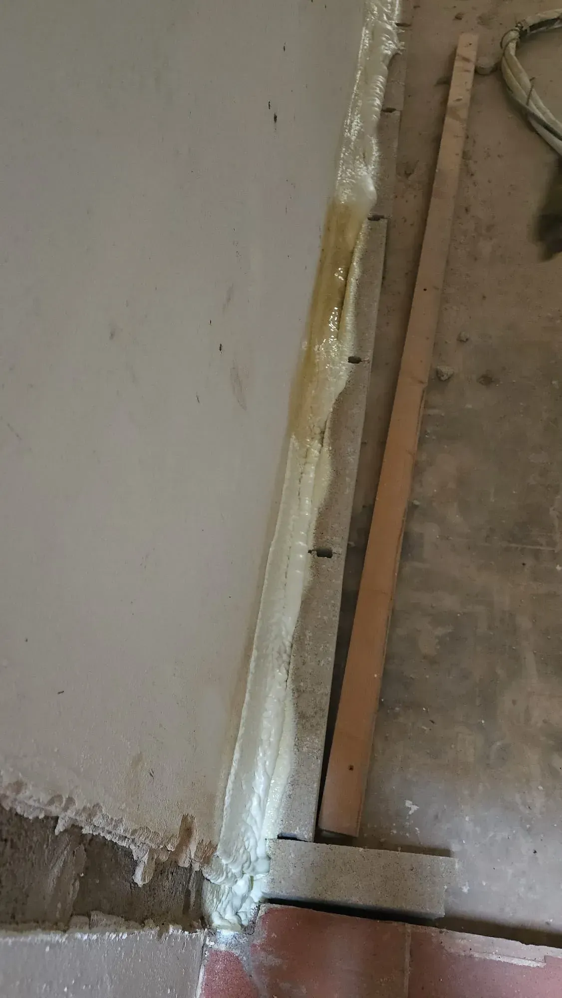 Un primer plano de una esquina de una pared con espuma encima.