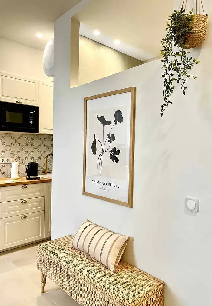 Una cocina con un banco y un cuadro en la pared.