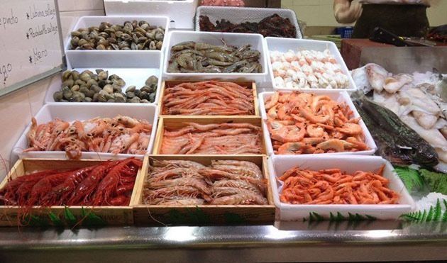 En un mostrador se exhibe una variedad de mariscos.