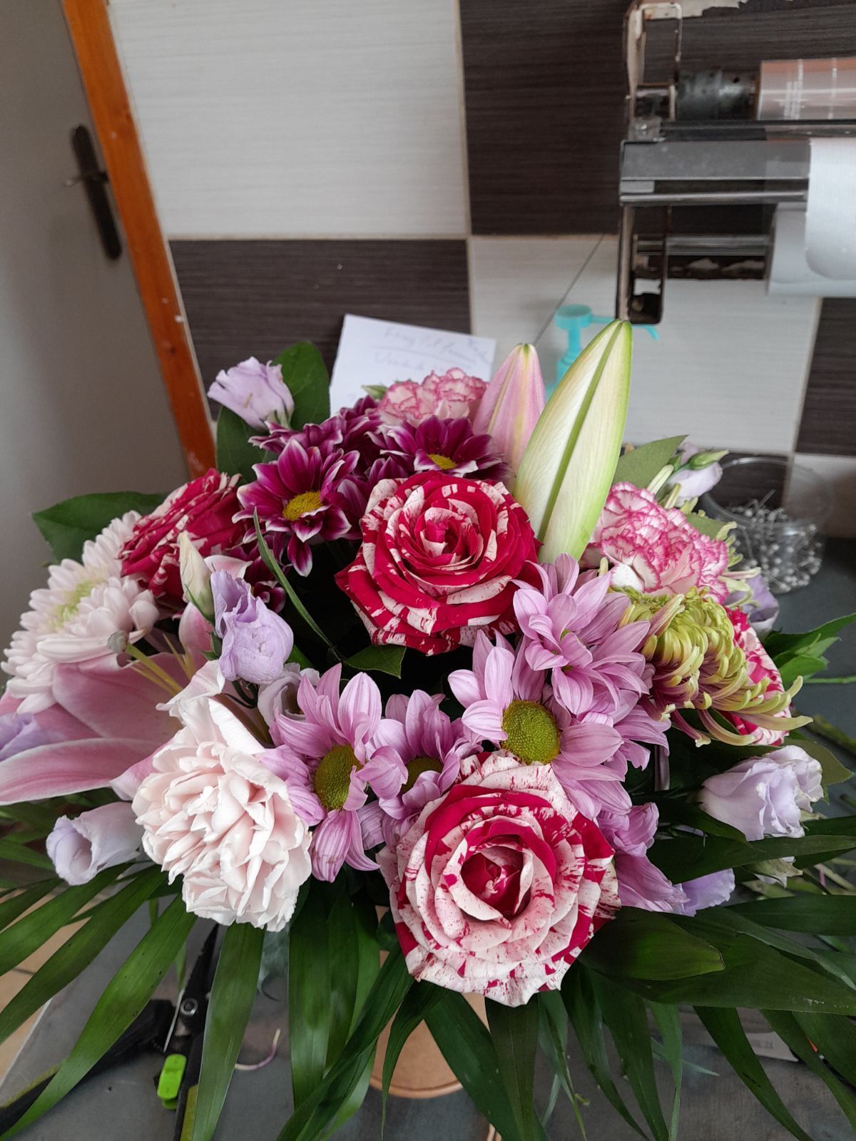 Bouquet rond composé de fleurs roses et rouges