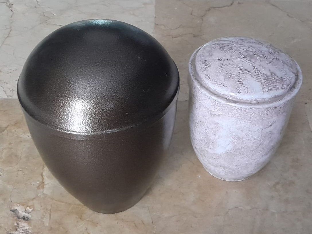 Dos urnas están colocadas una al lado de la otra sobre una mesa.