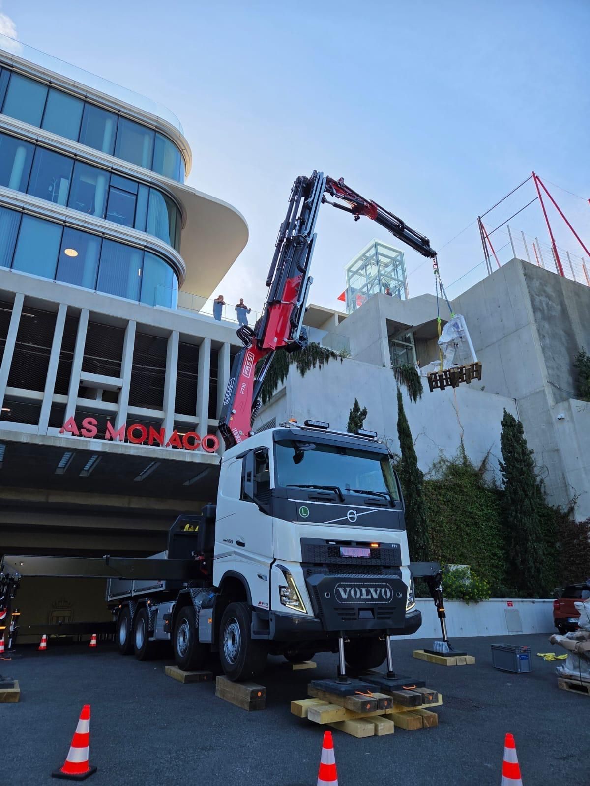 Camion-grue blanc soulevant des matériaux 