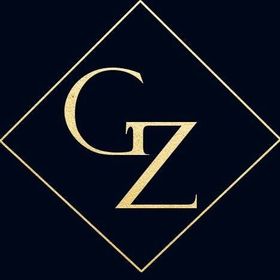 Una letra g y z dorada en un cuadrado sobre un fondo negro.