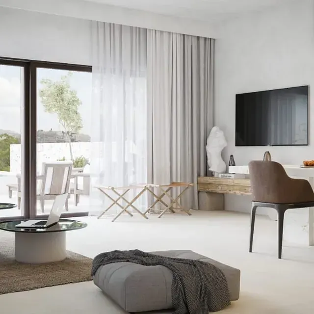 Una sala de estar con un televisor de pantalla plana grande en la pared.