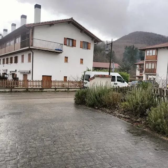Una camioneta blanca está estacionada frente a una casa blanca
