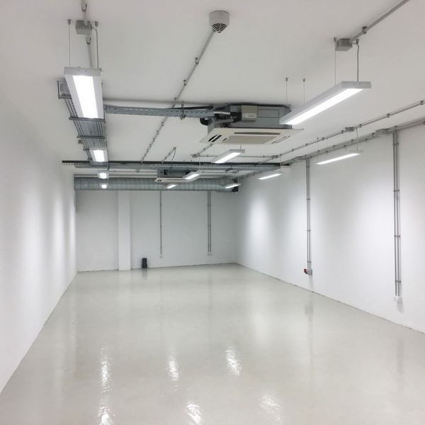 Una habitación vacía con paredes blancas y suelo blanco.