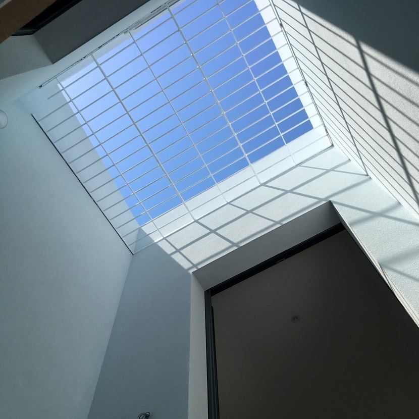 Mirando hacia un cielo azul a través de un tragaluz