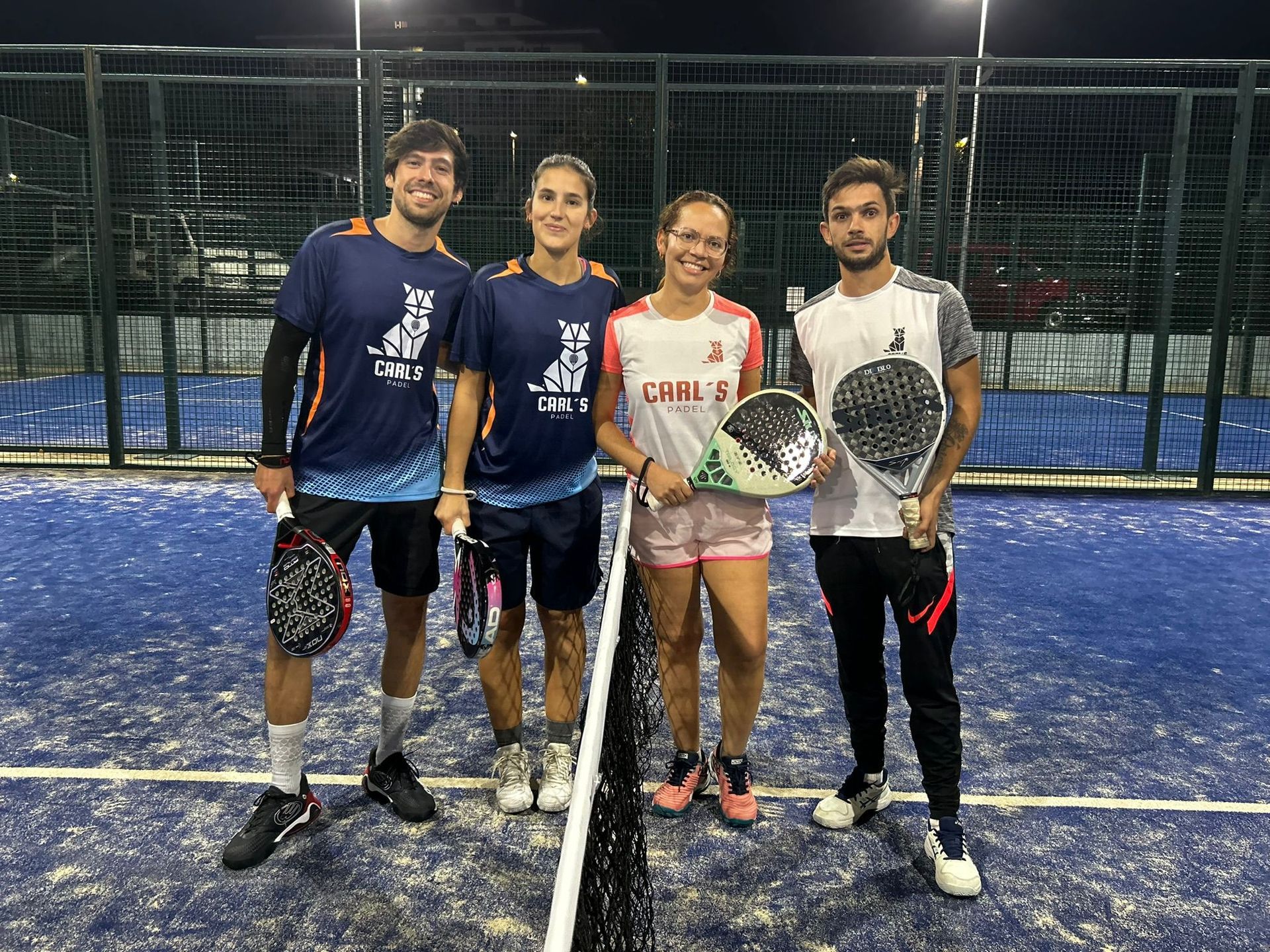 Un grupo de personas posa para una fotografía en una cancha de tenis.