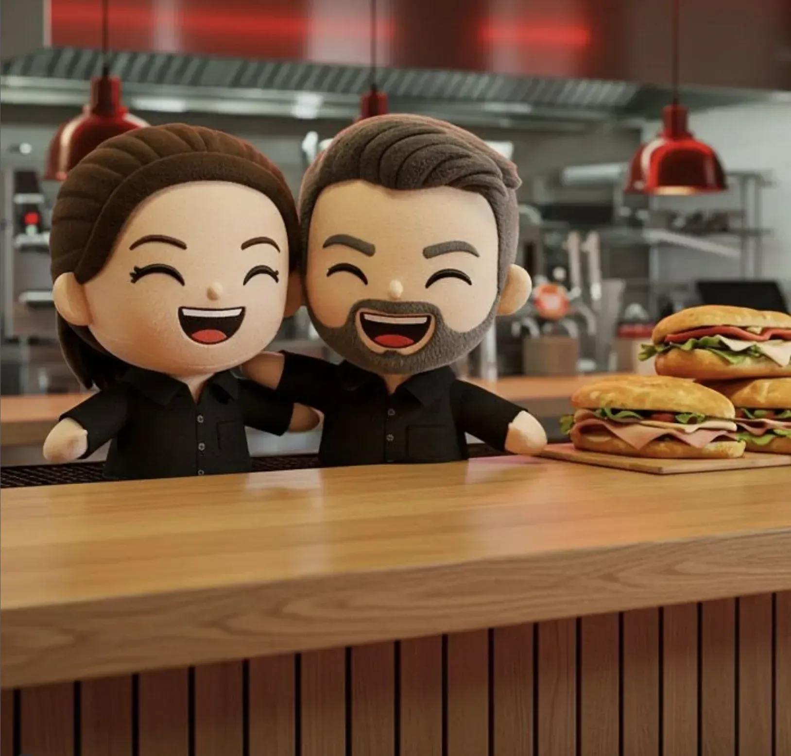 Un hombre y una mujer están sentados en un mostrador con sándwiches.
