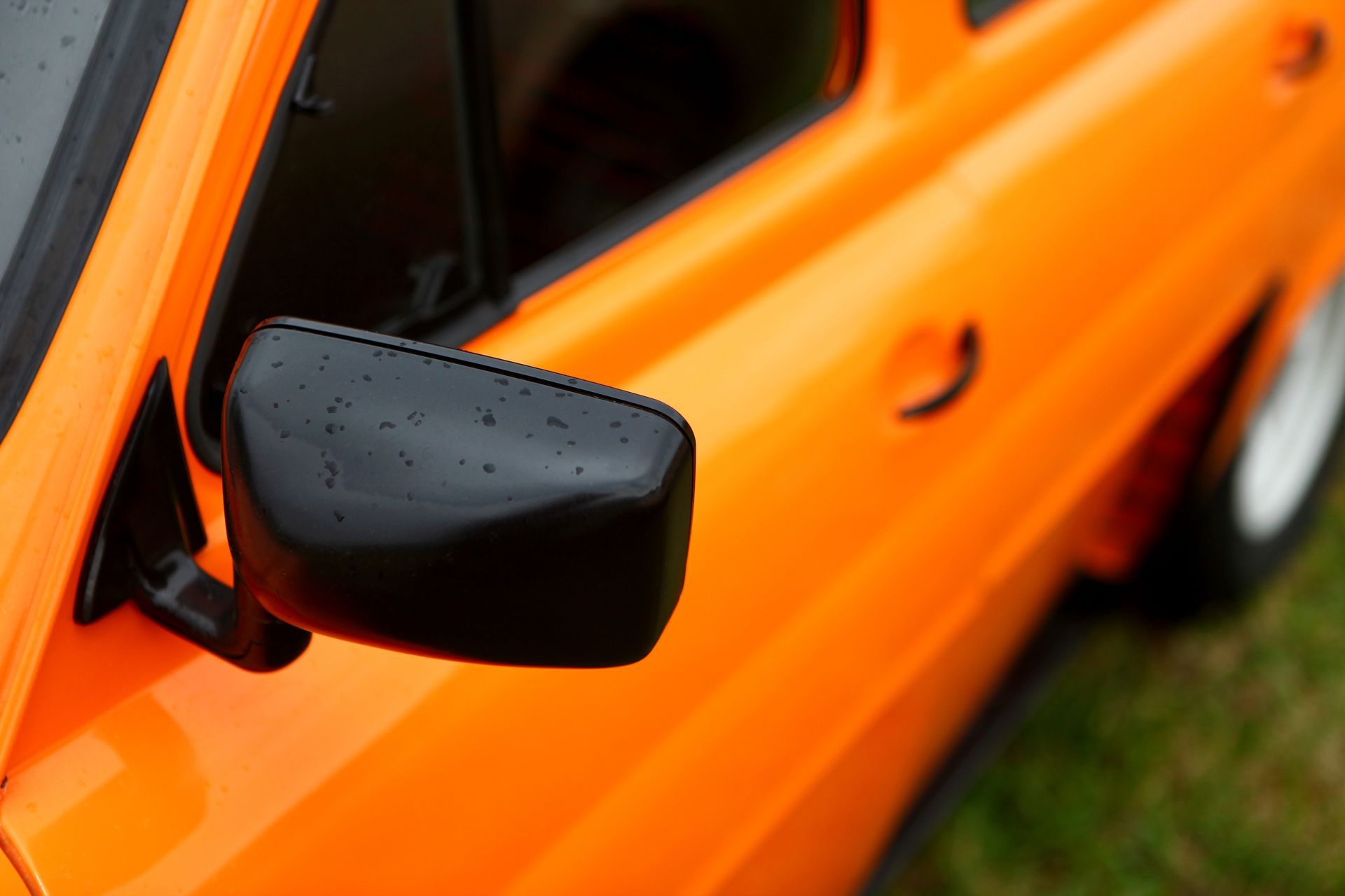 Une voiture orange sur de l'herbe