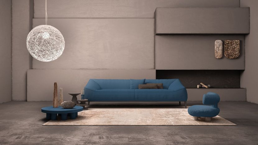 Salon moderne avec un canapé bleu, une suspension blanche ronde et une décoration grise minimaliste.