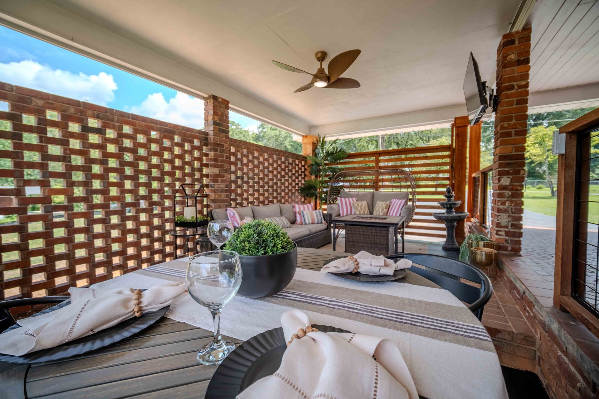 Patio area with comfortable seating with smart tv. Table for outdoor dining on the patio.