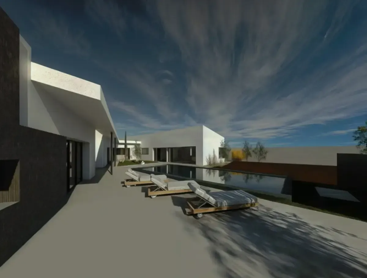 Edificio blanco moderno con piscina y tumbonas bajo un cielo azul con nubes.