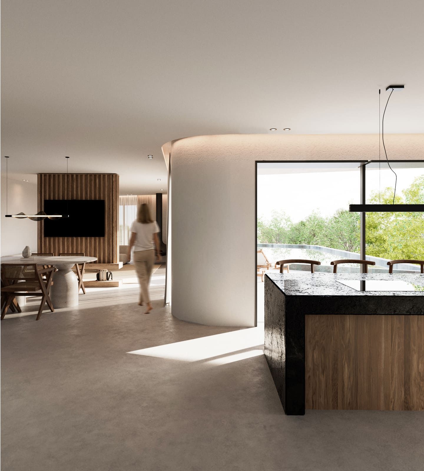 Interior moderno: isla de cocina con encimera de piedra, persona caminando, ventana con vista al exterior.