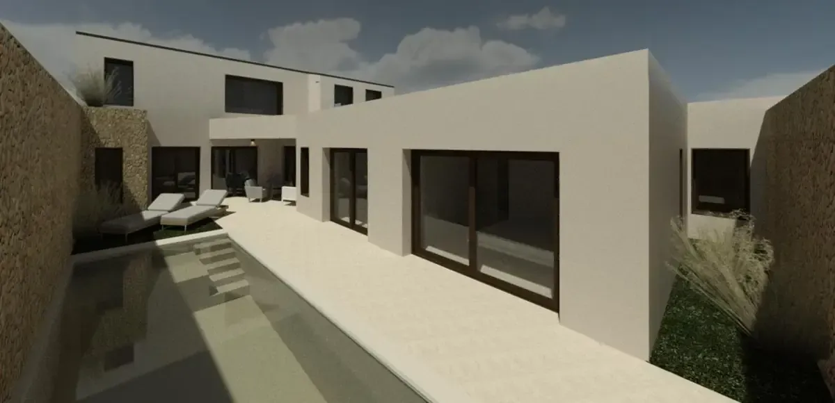 Moderna casa blanca con piscina, tumbonas y pared de piedra.