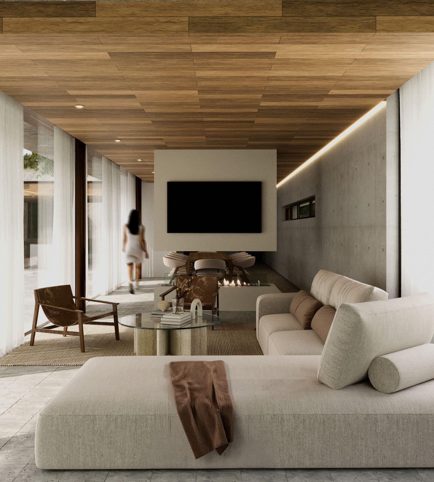 Moderna sala de estar con techo de madera, chimenea y una persona caminando hacia una pared de vidrio.