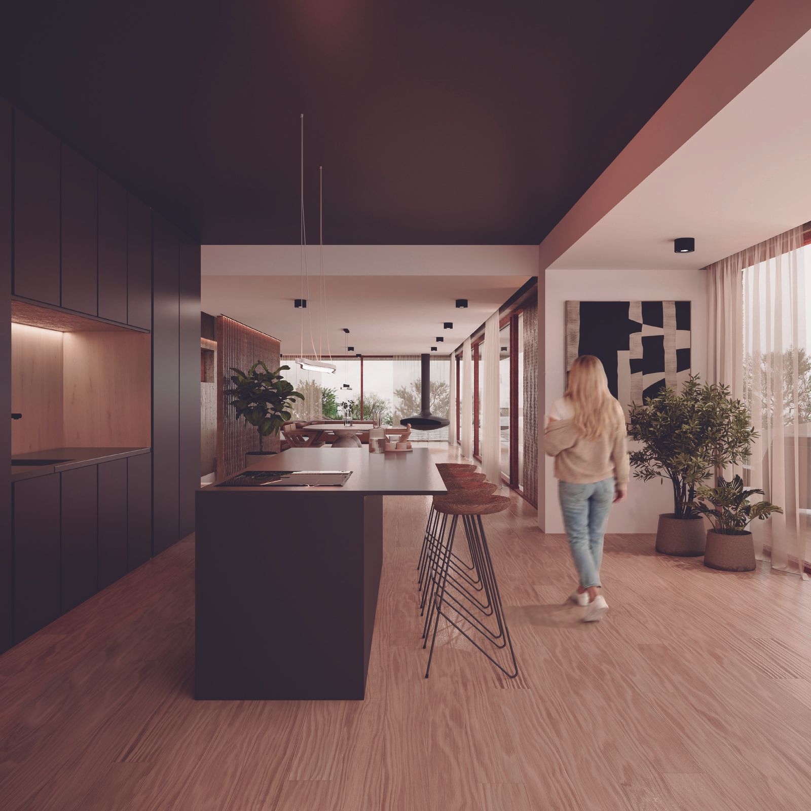 Mujer camina en cocina moderna con isla y vista al exterior.