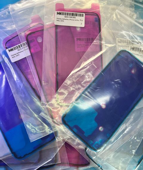 Un montón de teléfonos móviles están colocados uno encima del otro en bolsas de plástico.
