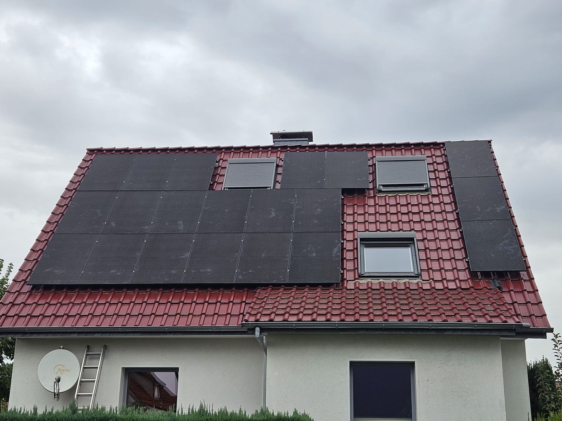 Ein weißes Haus mit Sonnenkollektoren auf dem Dach