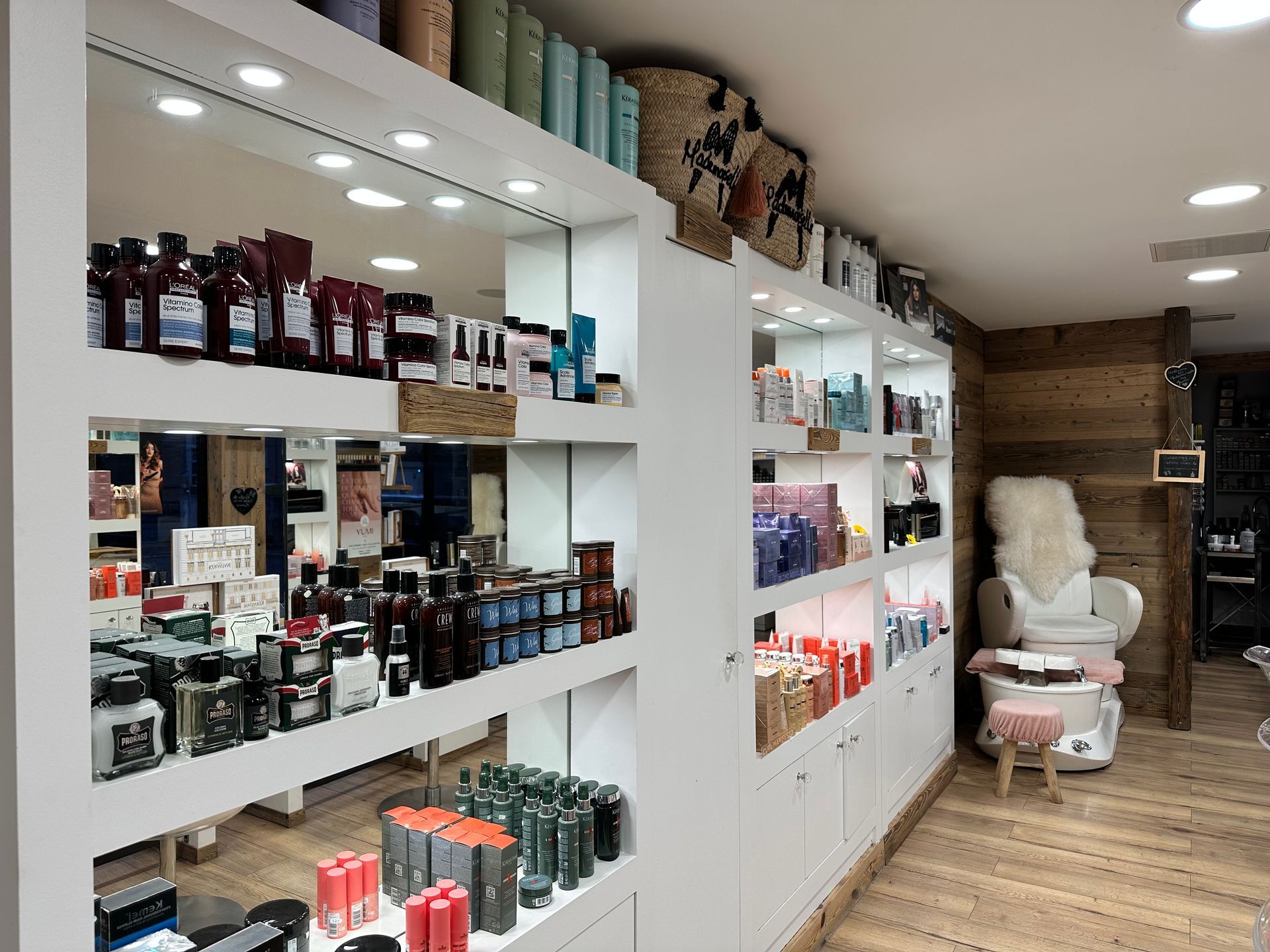 Présentoir pour salon de coiffure et d'esthétique, avec des étagères présentant des produits capillaires et de beauté