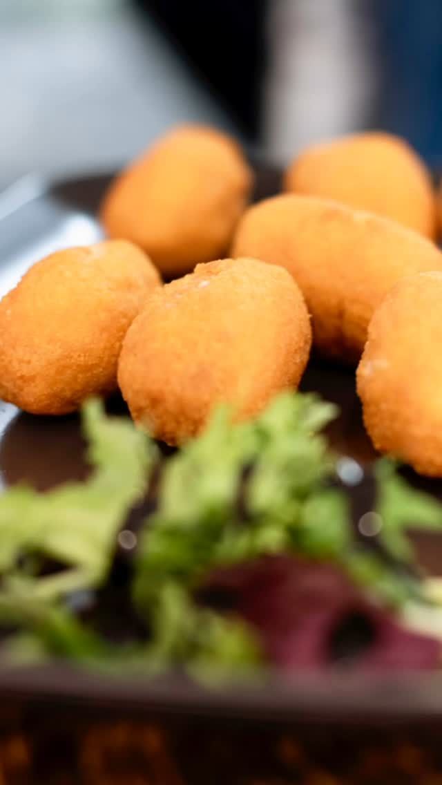 Un primer plano de comida frita en un plato con lechuga.