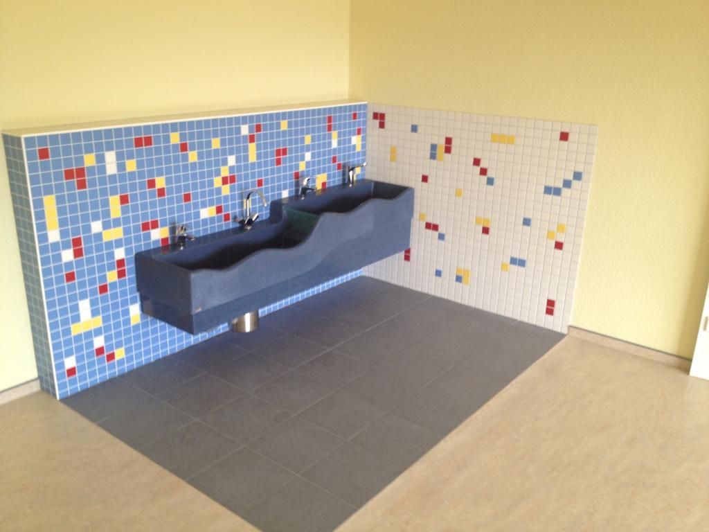 Waschbeckenbereich große Mosaikfliesen in weiß und hellblau mit bunten Fliesen zwischendrin