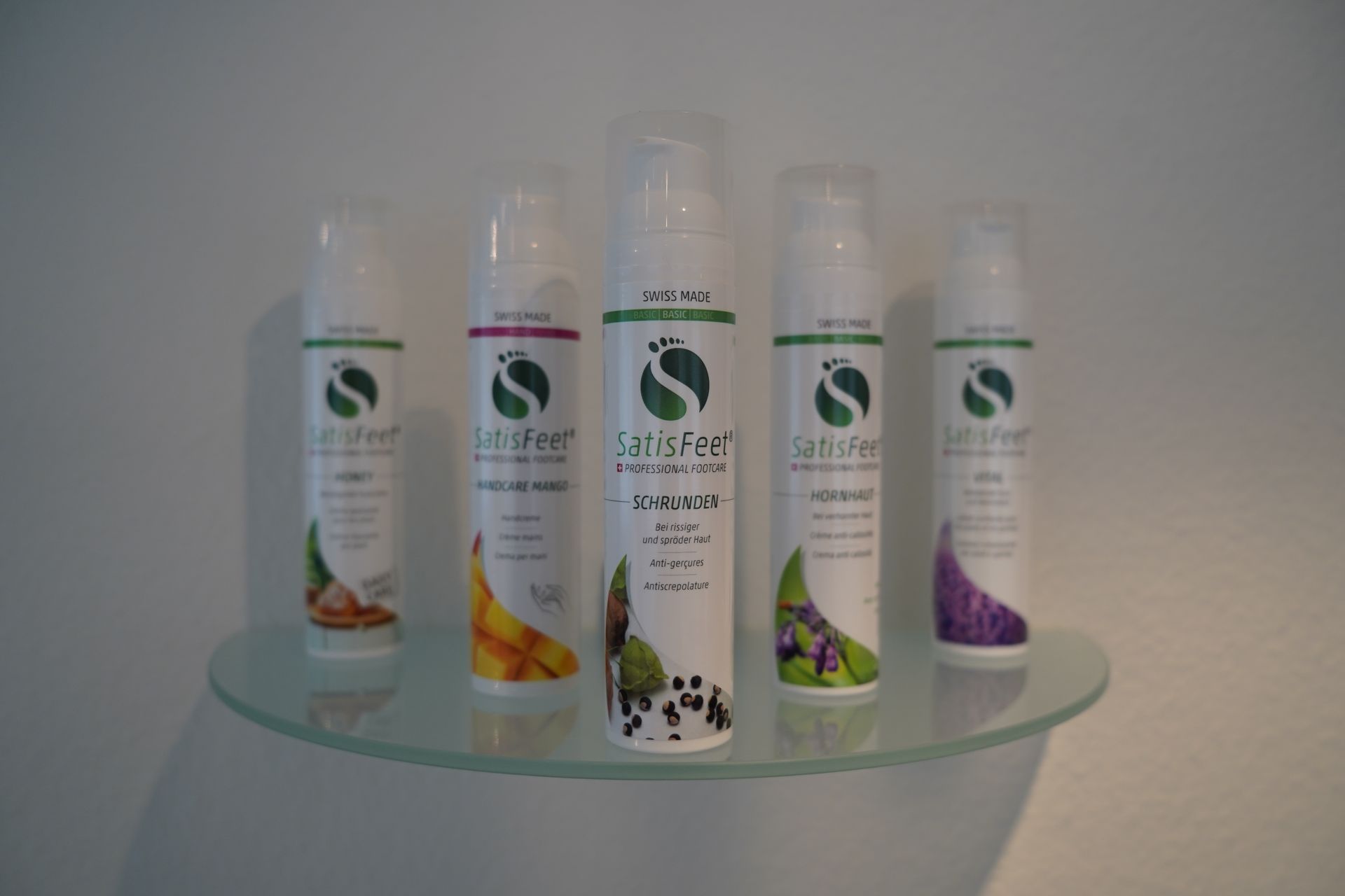 5 verschiedene Cremen auf Glas Tablar