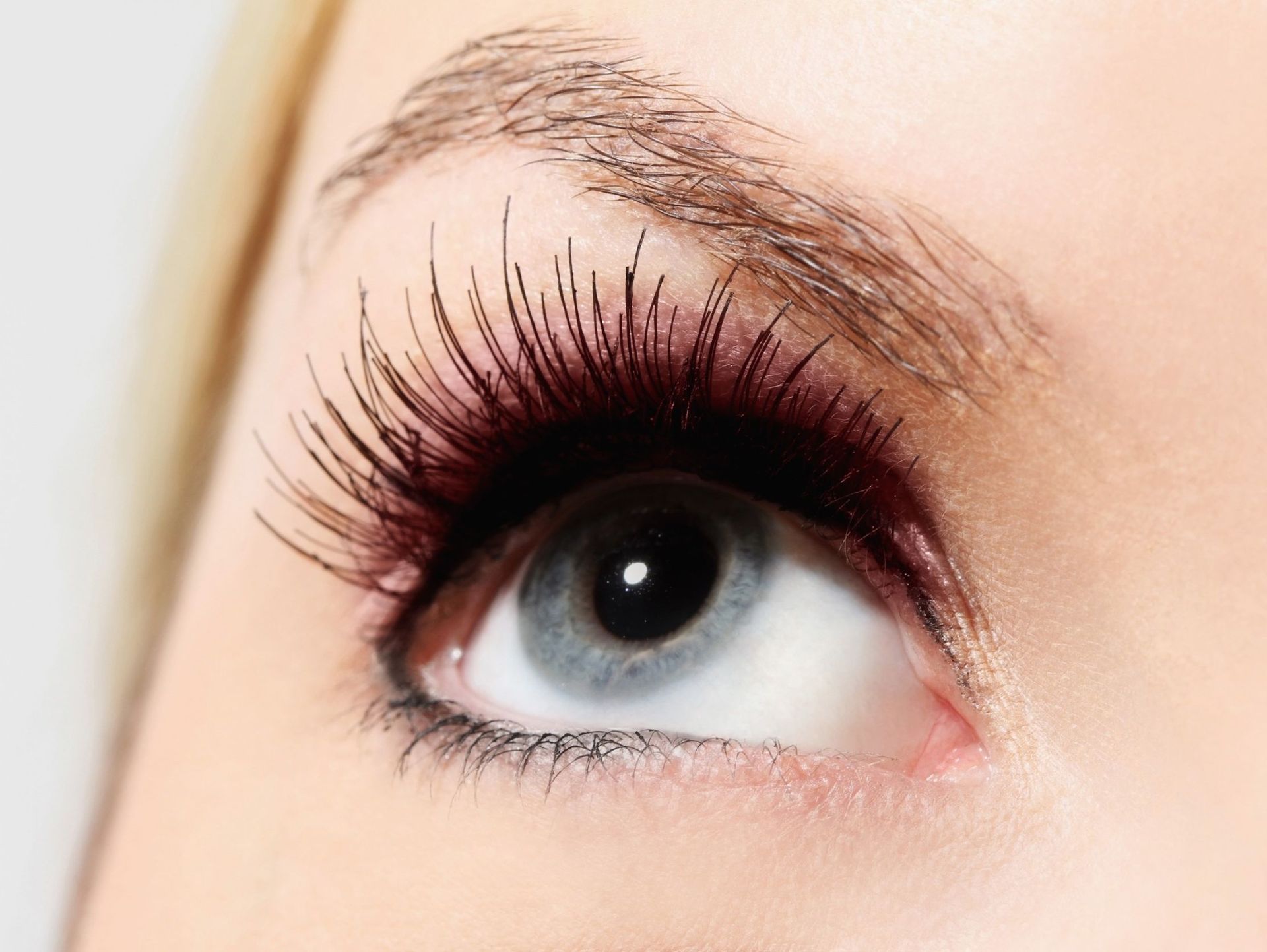 Un primer plano del ojo de una mujer con pestañas largas.