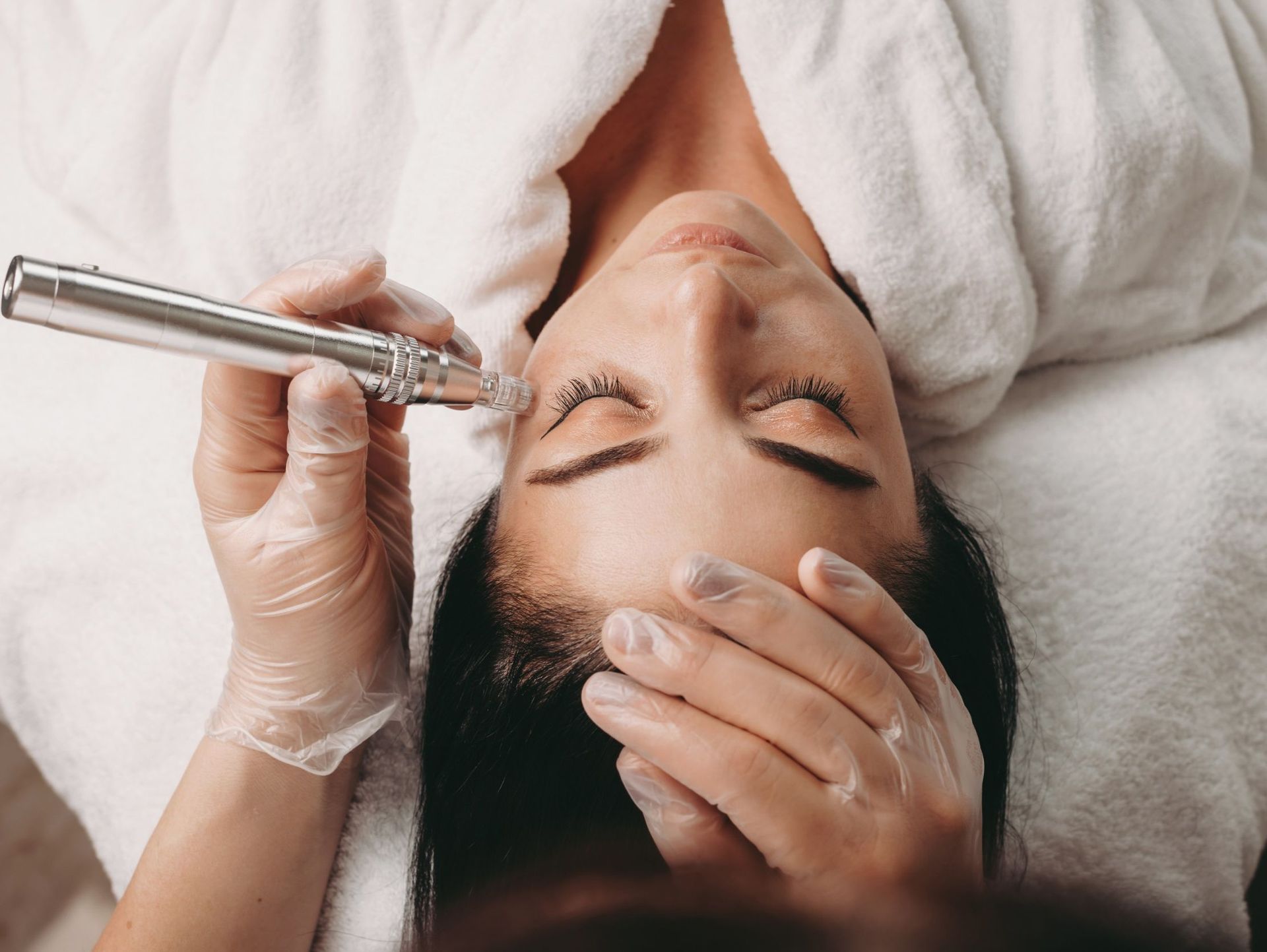 Una mujer está recibiendo un tratamiento de microdermoabrasión en su cara.