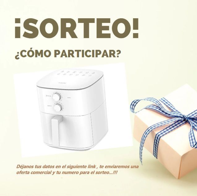 Una freidora de aire blanca está junto a una caja de regalo.