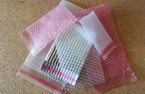 Un lápiz labial está envuelto en plástico de burbujas sobre una mesa.