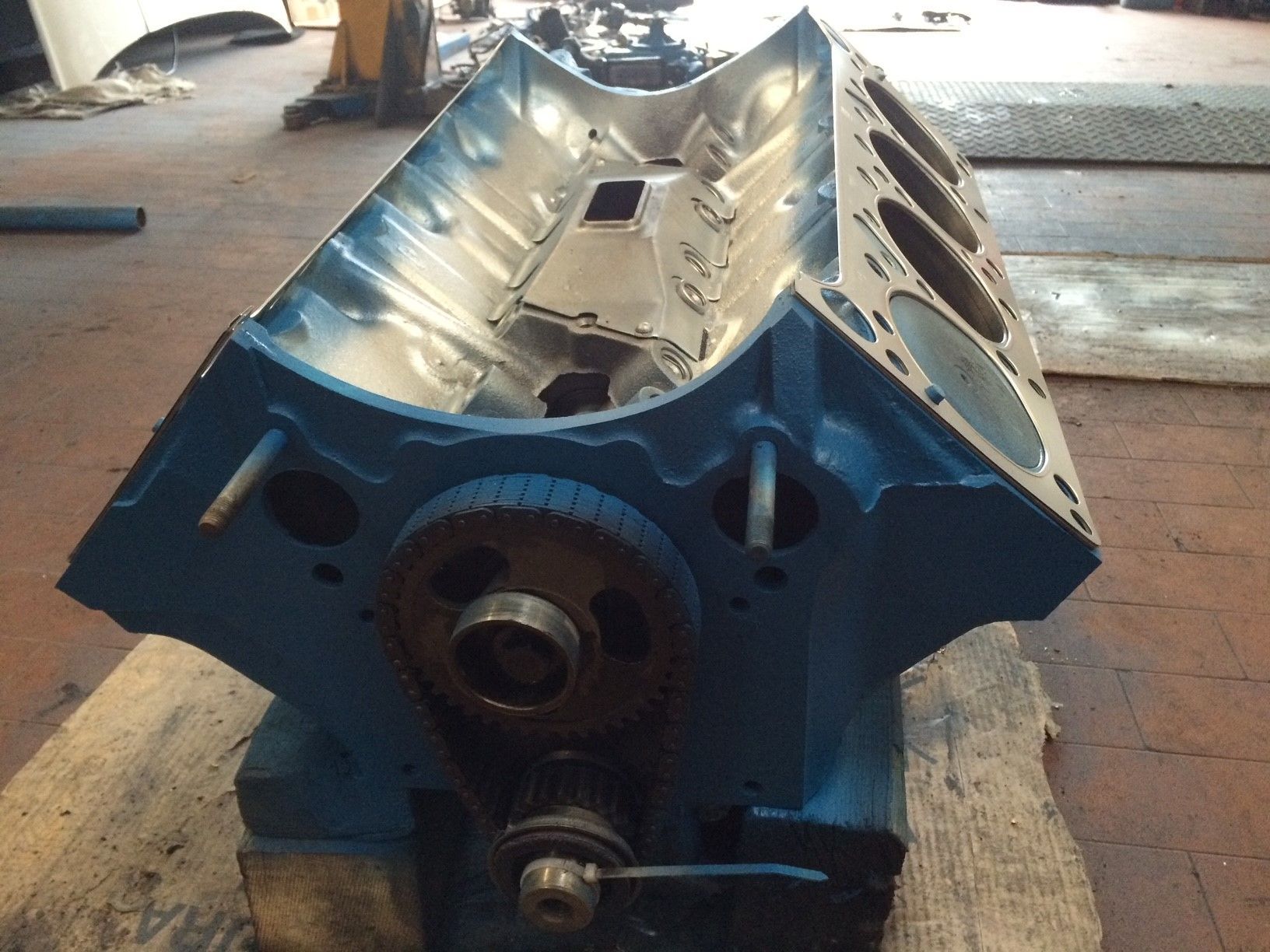 Ein blauer Motorblock sitzt auf einem Holztisch