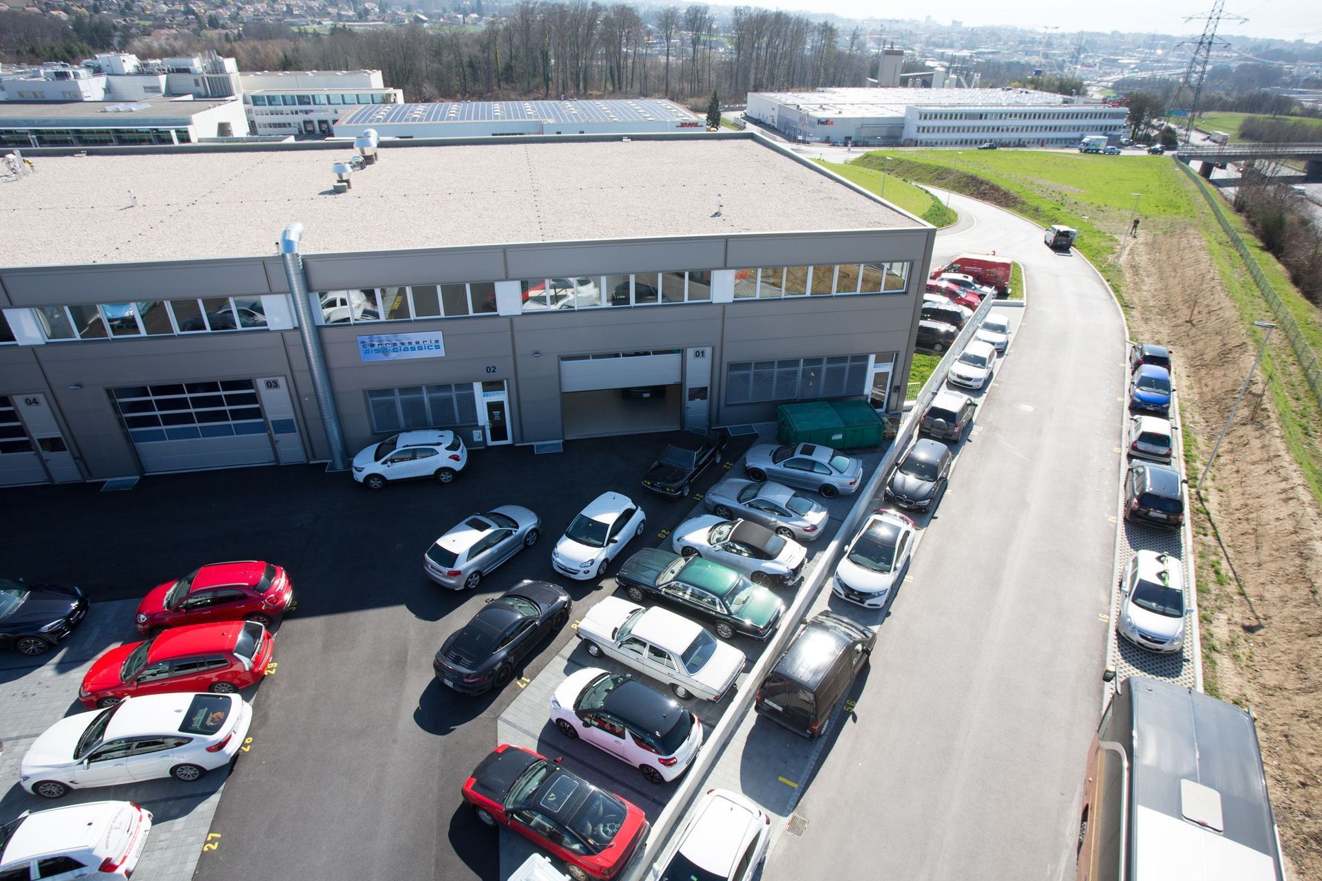 Beaucoup de voitures sont garées devant un bâtiment