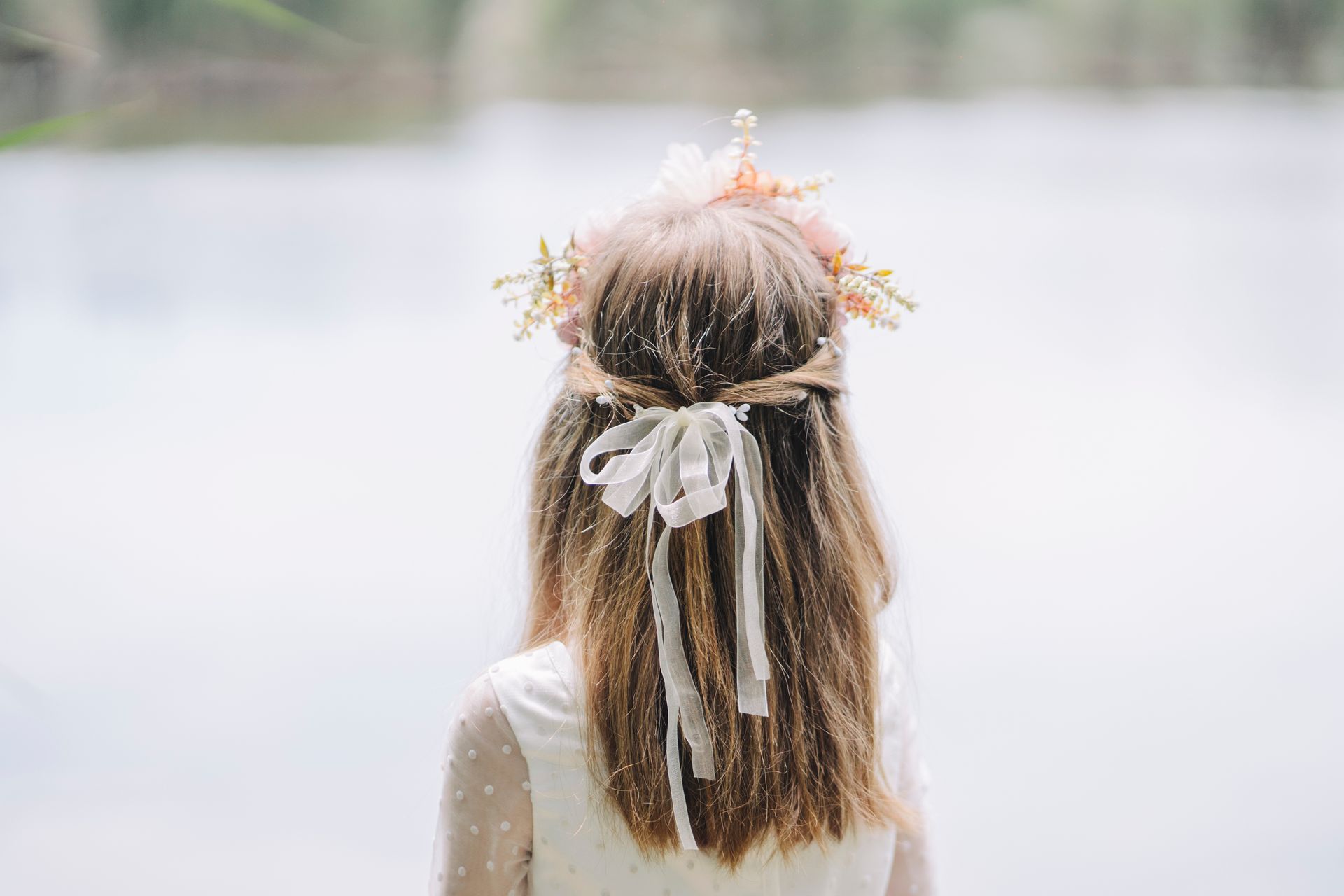 Femme avec une couronne de fleurs et des rubans.