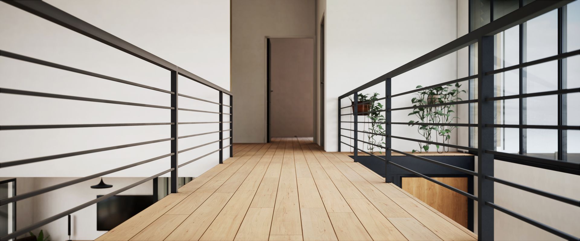 Allée en bois avec rambarde en métal noir menant à une porte. Plantes sur le côté droit.