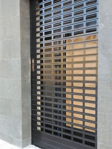 Un primer plano de una persiana enrollable negra en un edificio.