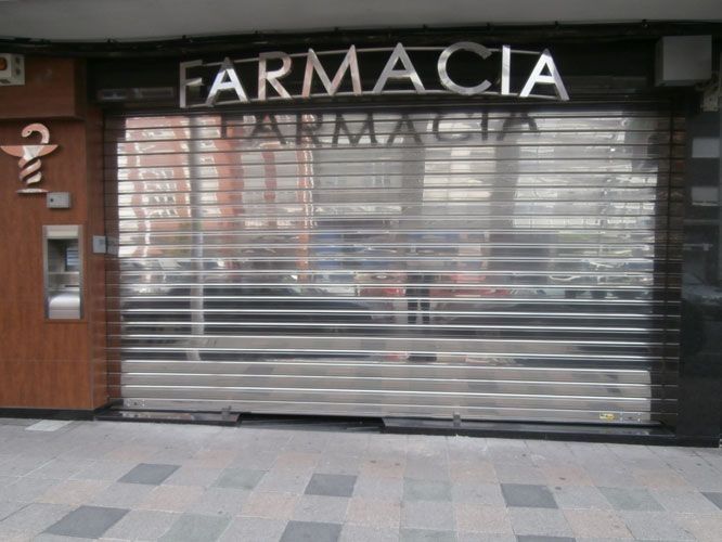 Una farmacia con persiana enrollable de acero inoxidable