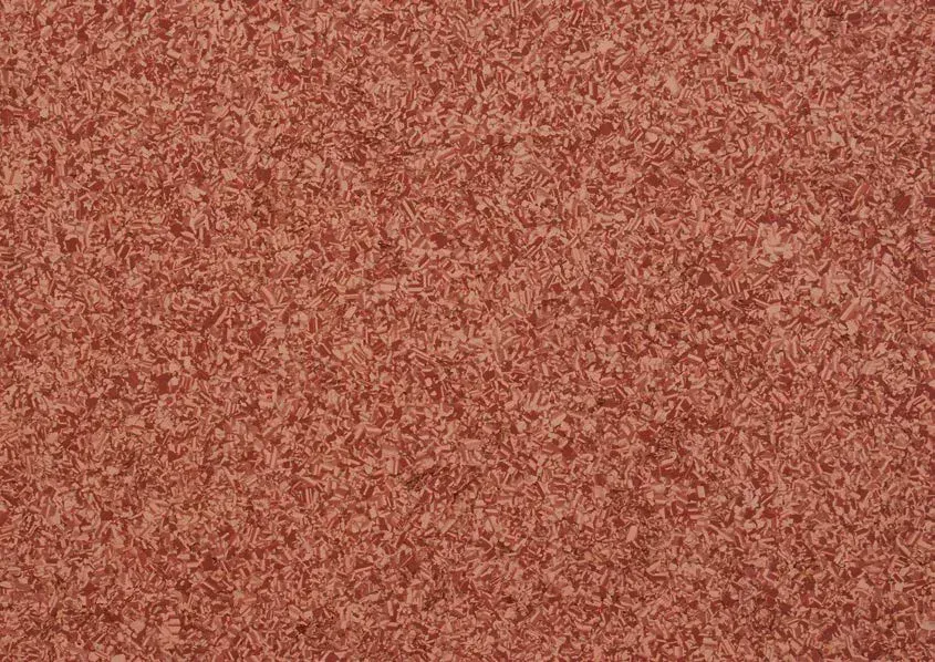 Ein strukturiertes, gesprenkeltes Muster in verschiedenen Rotbraun- und Terrakottatönen.