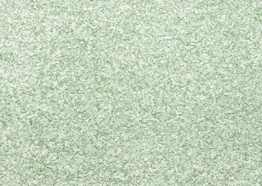 Eine helle, salbeigrüne Textur mit einer feinen, gesprenkelten und leicht körnigen Oberflächenstruktur.