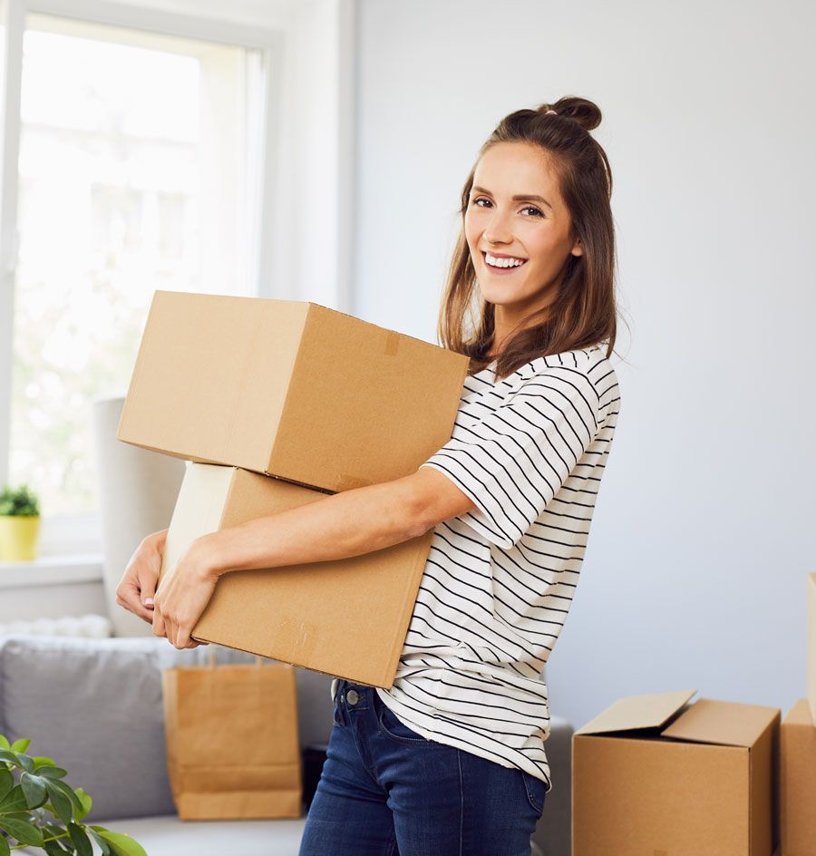 Jeune femme brune portant des cartons