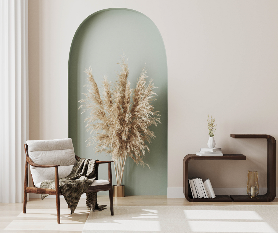 Chambre minimaliste moderne avec alcôve cintrée, fauteuil, décoration en herbe séchée et petite table bibliothèque