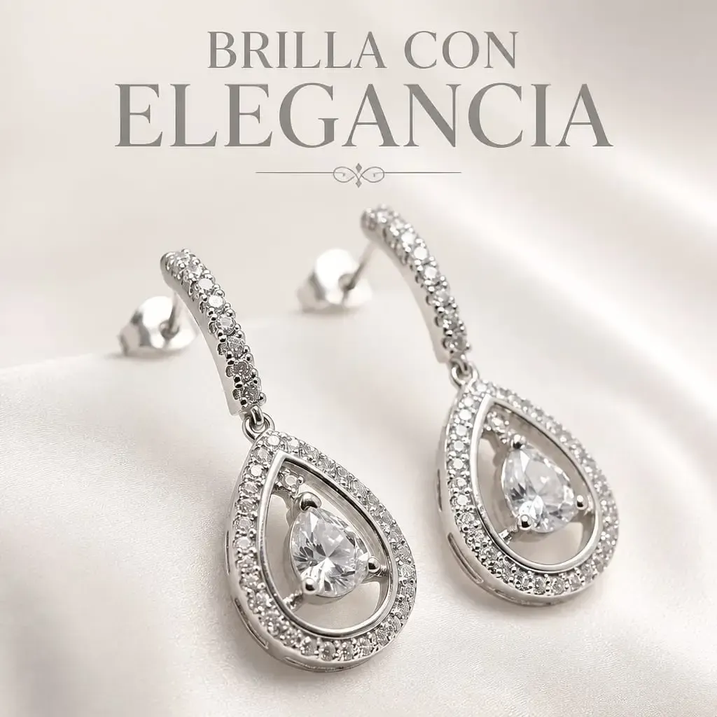 Anillo de plata sobre guijarros negros lisos sobre un fondo oscuro.