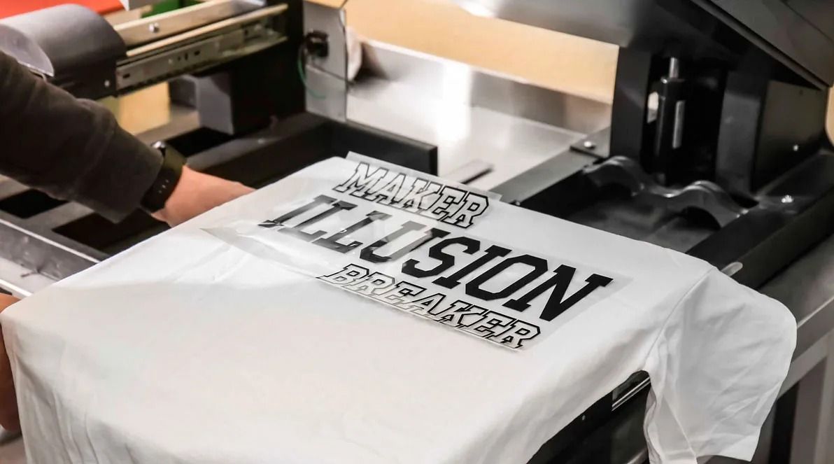 Una persona está imprimiendo una camiseta con la palabra ilusión.